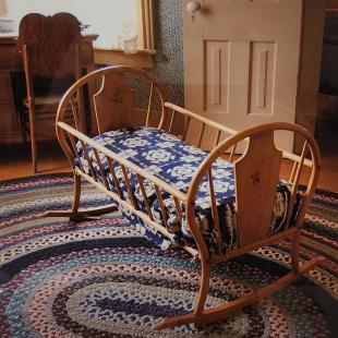 Cradle in the bedroom at the Willa Cather Childhood Home