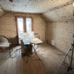Cather's attic bedroom staged with supplies for conservation work.