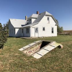 Pavelka Farmstead with the root cellar in the foreground prior to restoration efforts.
