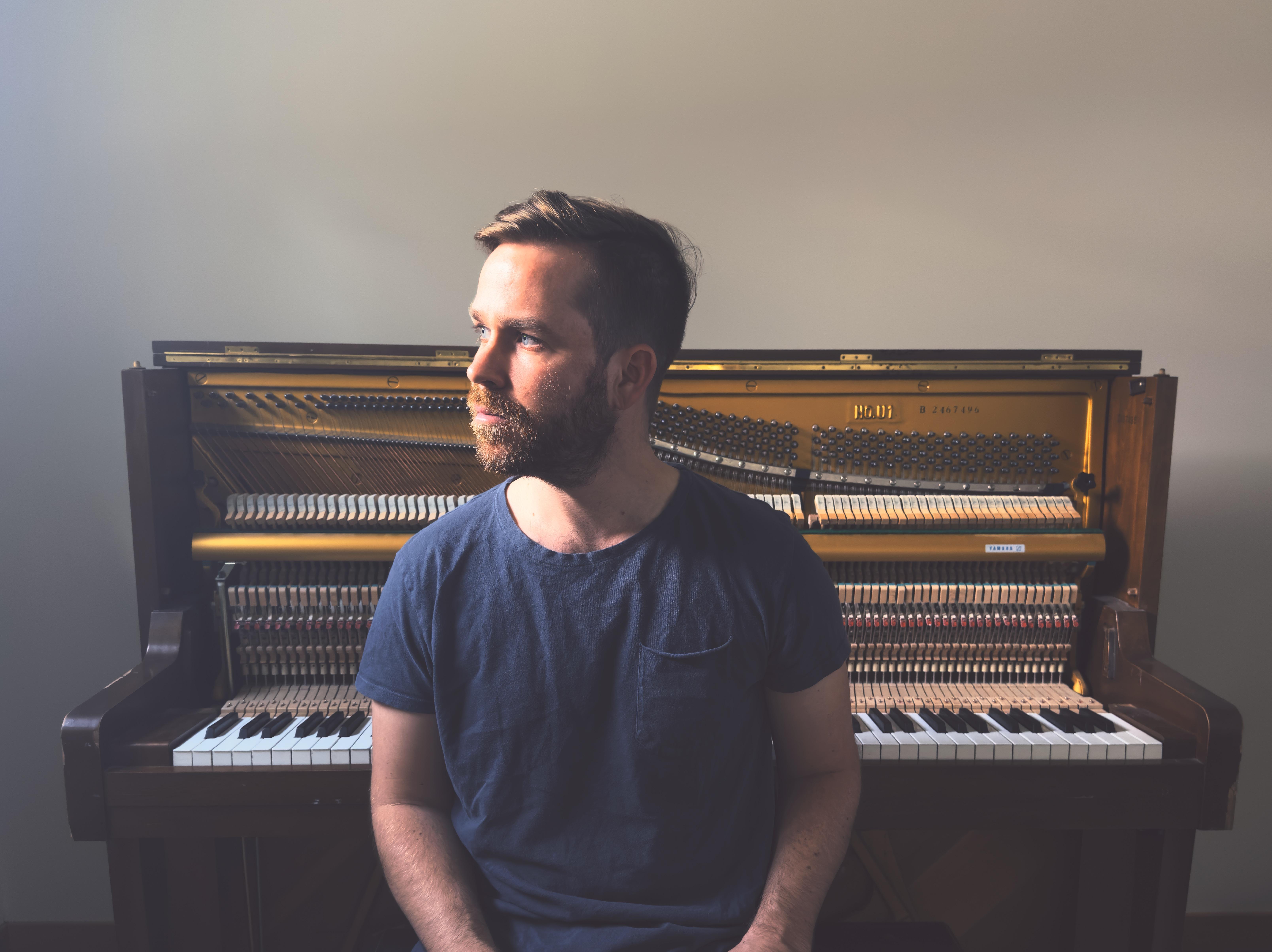 Philip Daniel seated in front of a piano