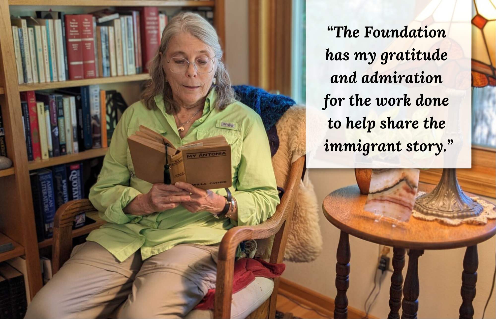 Abbie Loomis sits in her rocking chair with My Antonia in hand. Quote: The foundation has my gratitude and admiration for the work done to help share the immigrant story.”
