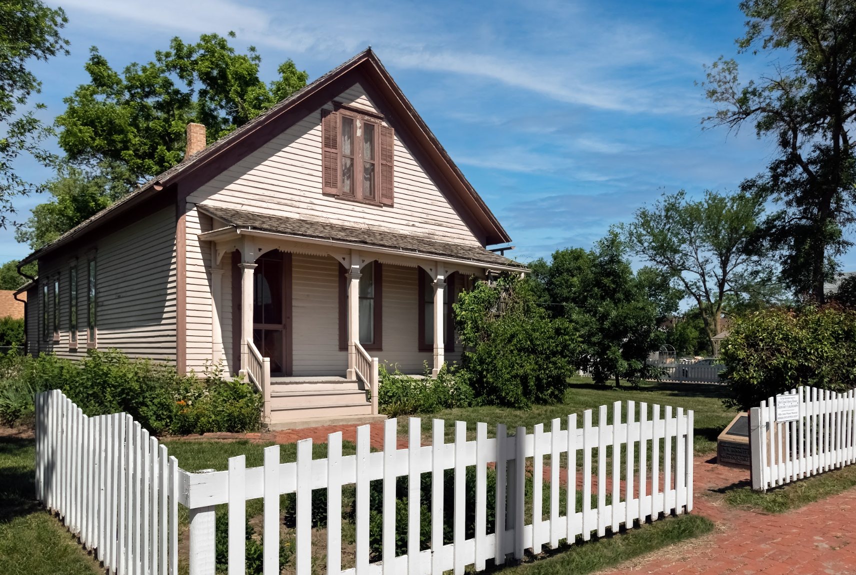 Exterior of the Willa Cather Childhood Home, surrounded by a picket fence