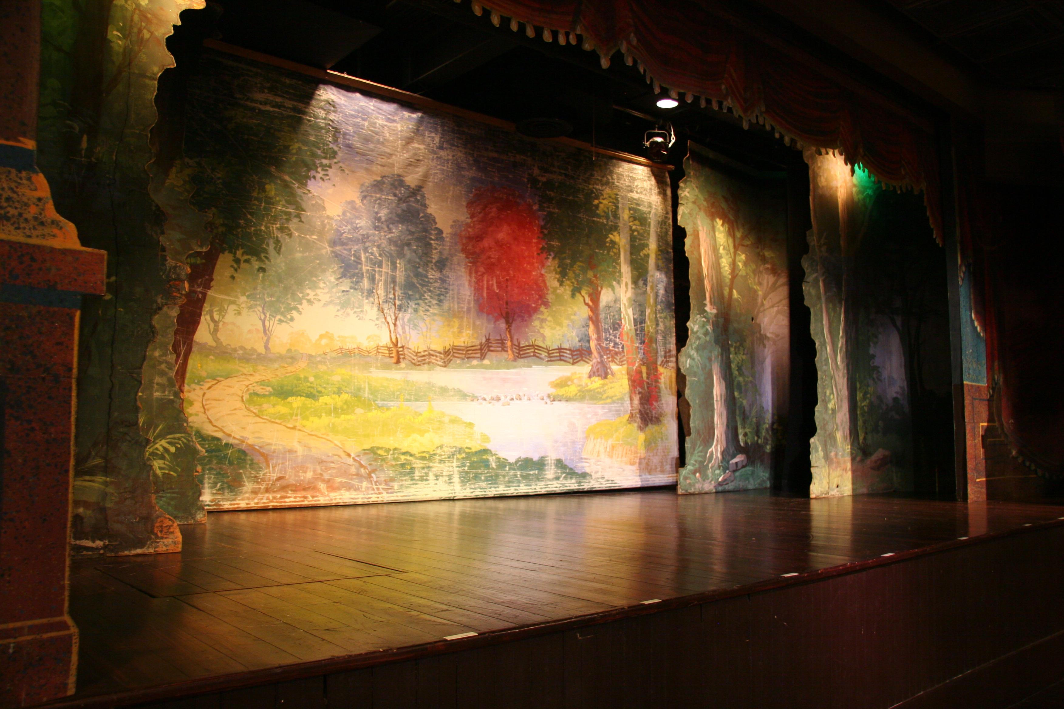 Red Cloud Opera House stage with historic backdrop and dramatic lighting