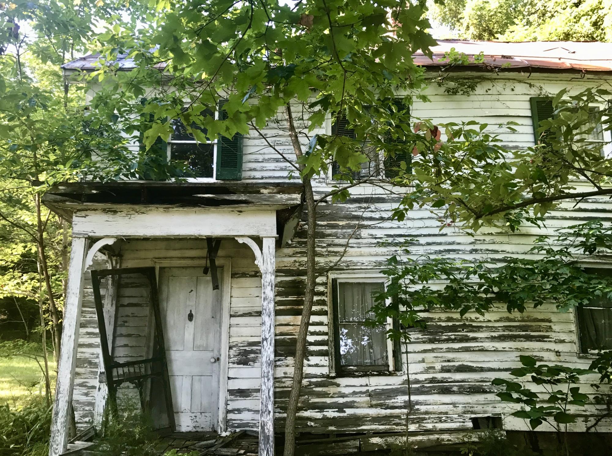 Willa Cather's birth home, a white farmhouse in disrepair