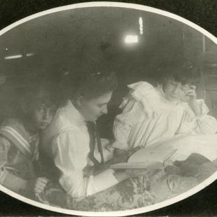 Willa Cather reads to Jack and Elsie Cather.