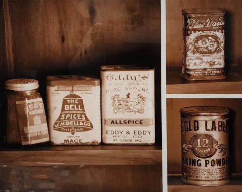 sepia toned photograph of antique spice tins