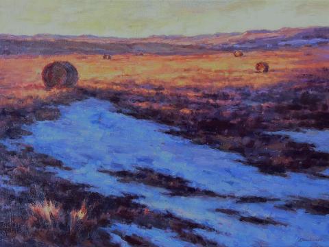 Snowy landscape with haybales